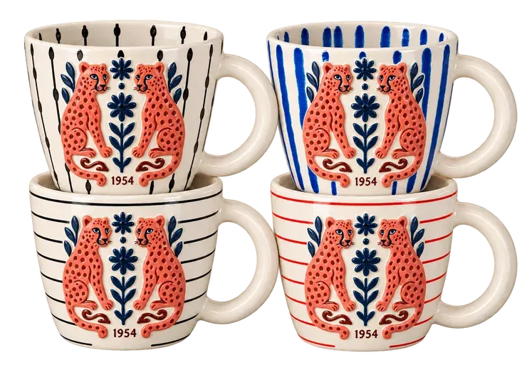 Twin Leopards, 1954, a set of four mugs. Two folk-art leopards face to face, with navy flowers and coral swirls.